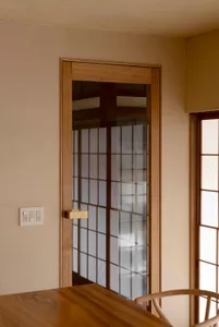 A modern kitchen with a wooden frame and glass door.