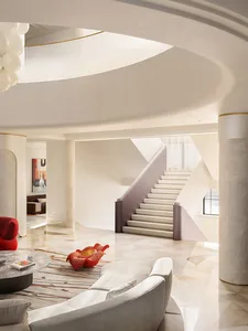 A modern residential interior featuring a marble staircase with sleek, curved lines and minimalistic design elements.