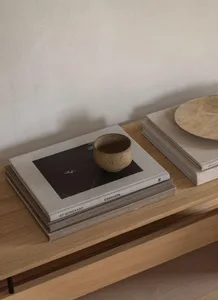 A minimalist home with a ceramic cup placed on cork surfaces.