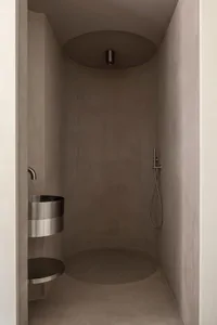 Modern bathroom with concrete walls and floor, minimalist design.