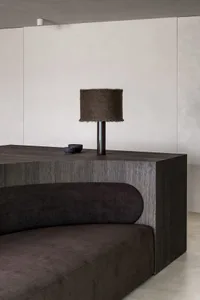 A modern living room featuring a wooden sideboard and a fabric sofa.