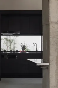 Modern industrial kitchen with black cabinets and metallic accents