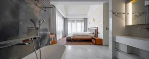Modern bedroom suite featuring marble finishes and contemporary design elements.