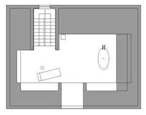 A minimalist bedroom with white walls and a wooden floor.