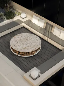 Modern patio furniture set with a round marble table and built-in seating made of concrete, surrounded by a landscaped area w