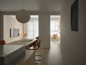 Modern residential interior featuring light wood and concrete materials.