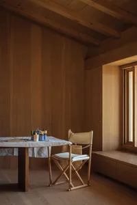 A minimalist interior design featuring wooden furniture and architecture.