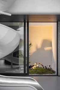 Interior design of a modern bathroom featuring glass walls and a minimalist design.