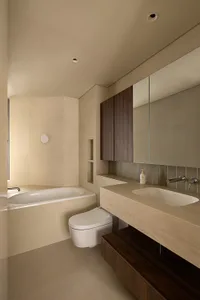 Contemporary bathroom interior with white tile walls, marble accents, and modern fixtures.