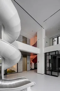 Modern interior design featuring concrete, steel, and glass elements.