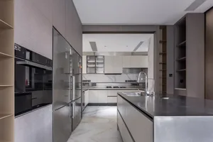 Modern kitchen with marble countertops and stainless steel appliances