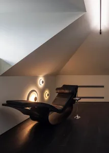 A modern leather recliner with minimalistic lighting design in a living room setting.