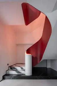 Modern metal stairs with a red protective railing
