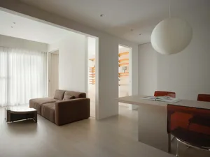 Modern minimalist living room with wooden furniture and fabric accents