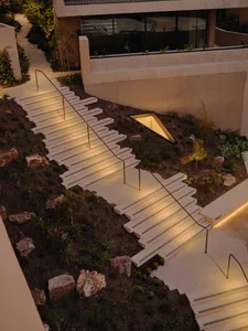 Concrete stairs with lighting in a landscaped outdoor area.