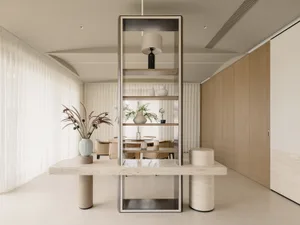 A modern residential kitchen featuring a marble countertop, metal accents, and wooden cabinets.