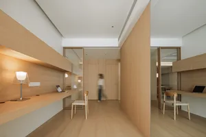 A minimalist office space featuring wooden furniture and a modern design.
