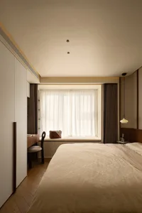 A modern bedroom featuring a beige bed with a cozy, comfortable fabric texture, accompanied by minimalistic window treatments