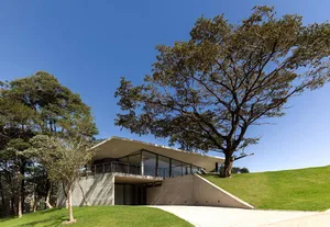A modern house featuring a concrete exterior and glass windows.