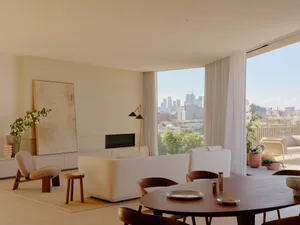 A modern, minimalist living room with a view of the cityscape.