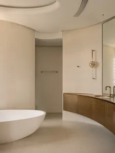 Modern minimalist bathroom with concrete texture walls and a freestanding bathtub.