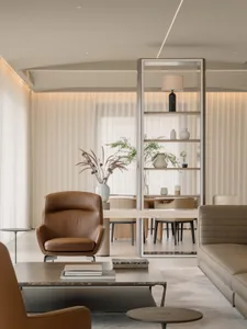Modern living room with neutral-toned leather furniture, minimalist decor, and large white curtains.