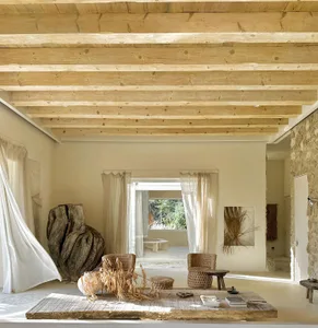 A minimalist beige living room featuring wooden elements and a cozy, neutral color palette.