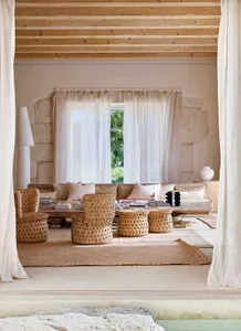 A minimalist living room featuring natural fiber furniture and neutral color palette