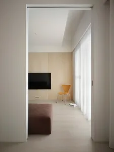 A modern minimalist living room with wooden elements and a sleek, stylish interior.