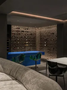 Modern minimalist wine bar with concrete walls and glass bar counter