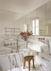 A modern bathroom featuring marble accents and fixtures.
