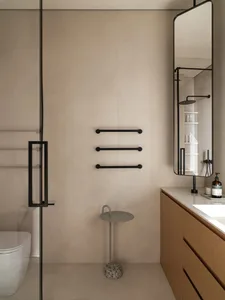 Modern minimalist bathroom featuring glass shower enclosure, minimalist vanity, wooden cabinetry, and concrete floor.