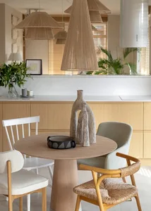 Modern dining room with wooden furniture and minimalist decor.