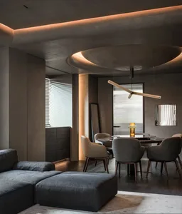 Modern living room featuring concrete walls and dark wooden furniture.