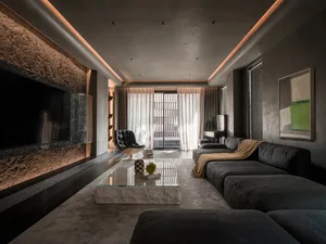 Modern living room featuring a concrete, teak, and marble design