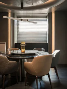 Modern minimalist dining room with marble table and leather chairs