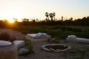 A peaceful outdoor living area with natural stones during sunset.