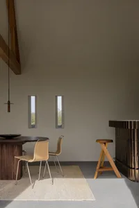 Industrial-style dining room featuring wooden furniture and a minimalist design.