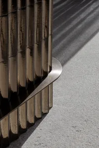 Industrial metal railing on a concrete floor, showcasing the play of light and shadow.
