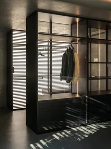A stylish industrial-style wardrobe with a minimalist design, featuring a black metal frame, wooden surfaces, and a large mir