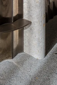 Metal column with a stone foundation in an architectural setting