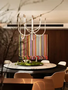 A modern dining room featuring a marble floor and wooden furniture.