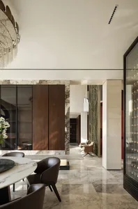 A modern dining room featuring marble flooring, glass cabinets, and wooden furniture.