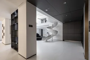 A modern house with minimalist architectural design, featuring concrete and white as primary materials.