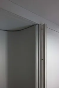 Modern industrial-style closet with metallic grey paneling and sleek, minimalist design.