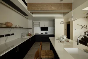 Modern residential kitchen with white marble countertops and black cabinets.