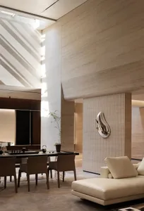 A modern living room featuring neutral-toned furnishings and a high-ceiling design.