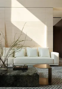 Modern white leather sofa in contemporary living room with natural light.