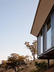 Modern house with steel and glass exterior on a hillside