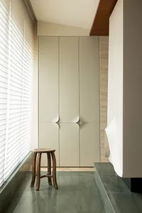 A modern flat-panel wardrobe with white doors and a minimalist design.
